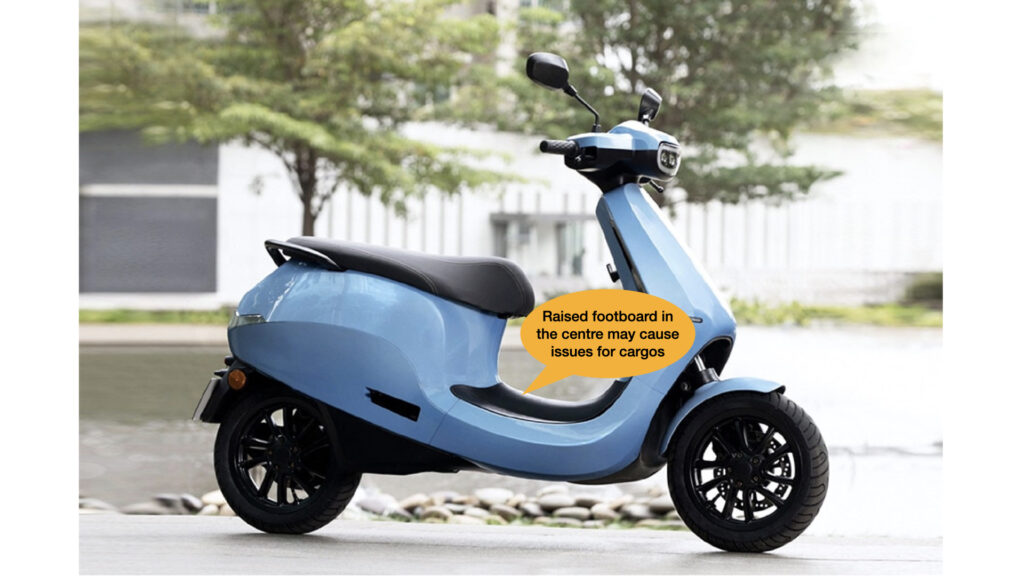 blue ola s1 scooter parked in front of trees